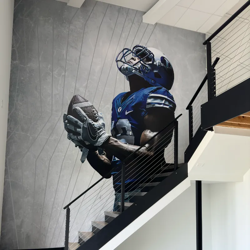 Champion vinyl wall graphic for branded environment by Uptimize