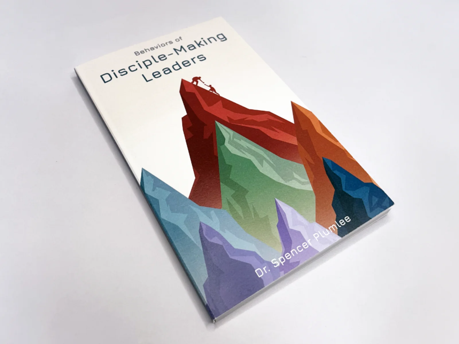 Behaviors of Disciple-Making Leaders book cover by Dr. Spencer Plumlee, featuring a layered mountain illustration with hikers reaching the summit