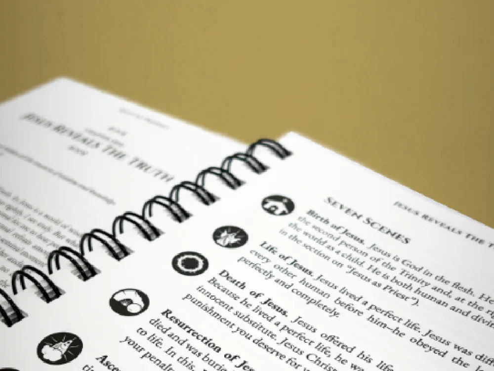 Christ Centered Discipleship interior page closeup showing the spiral binding and the 'Seven Scenes' iconography that runs through the book