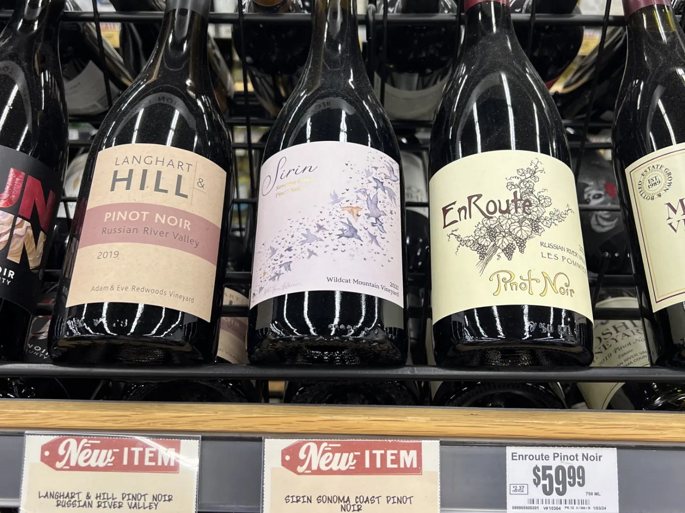Sirin Sonoma Coast Pinot Noir on the Central Market retail shelf between Langhart Hill and EnRoute Pinot Noir bottles, with 'NEW ITEM' shelf tags