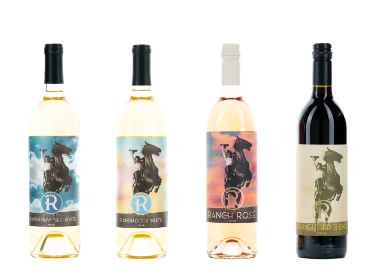 Ranch flagship wine lineup: Demi-Sec White, Doux White, Rosé, and Red Blend bottles featuring the rearing horse and cowboy label